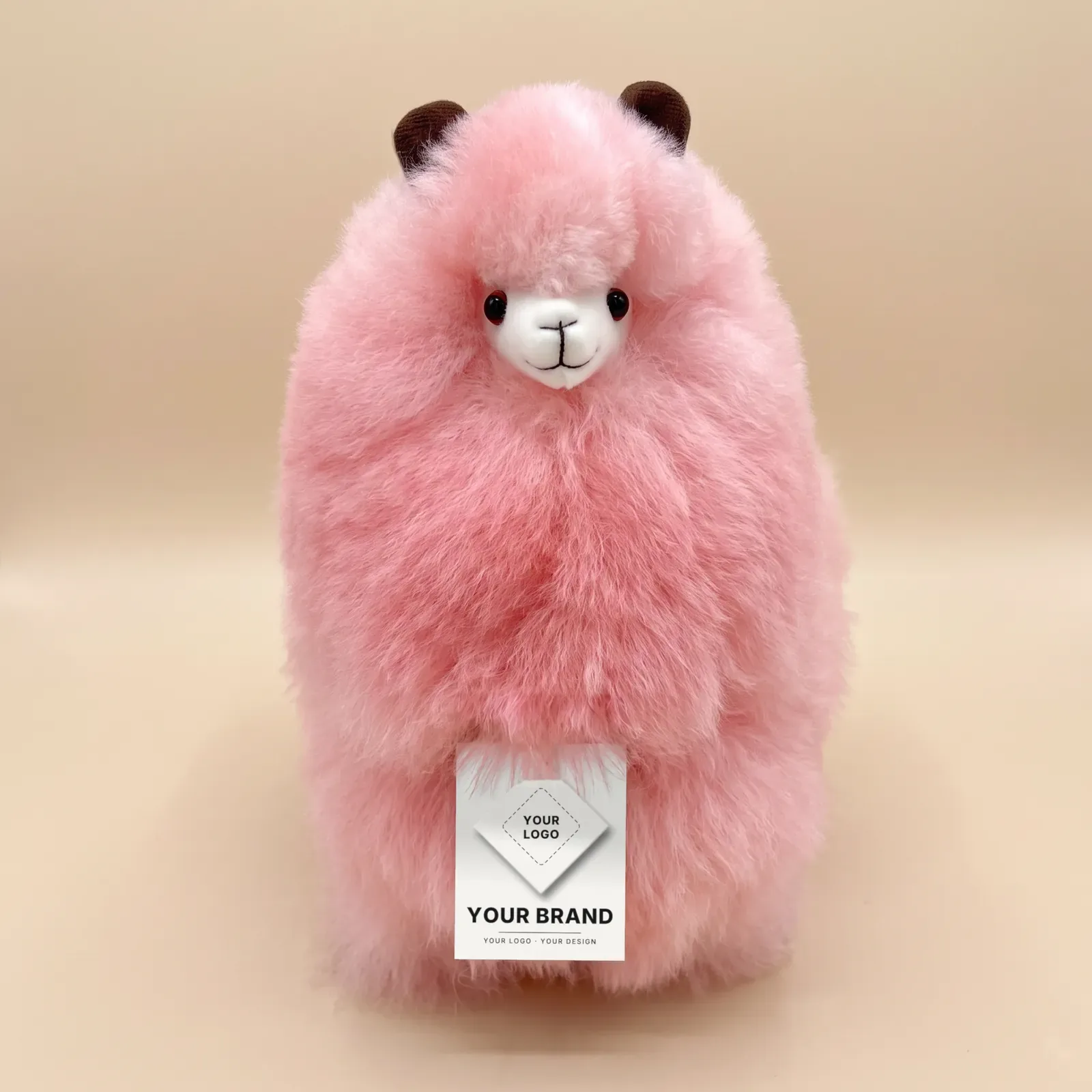 A Rainbow alpaca with a hang tag that reads Your Brand